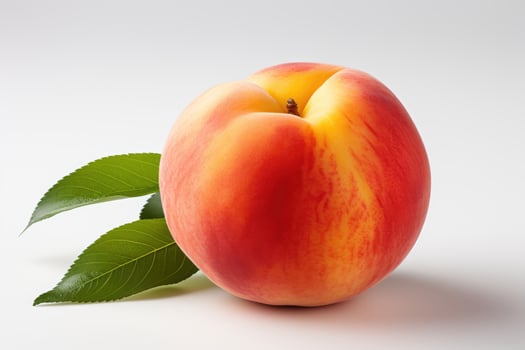 a peach with leaves on a white background photo