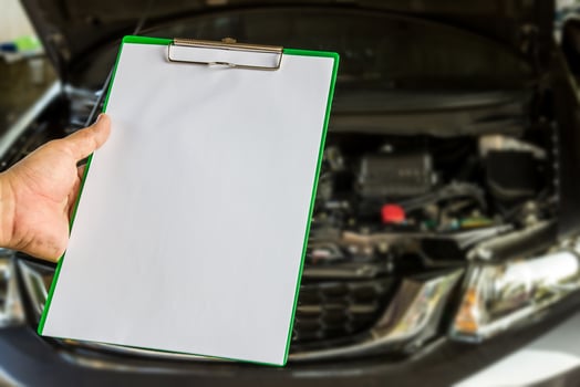 Hand a man hold check sheet paper for maintenance concept of car photo