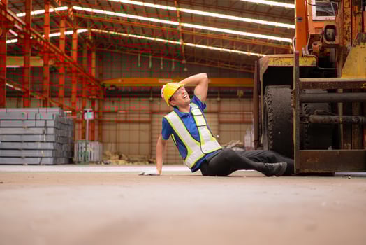 Young man working in a steel industry factory. He was critically hurt when a forklift ran over his leg and had to be transported to the hospital. photo