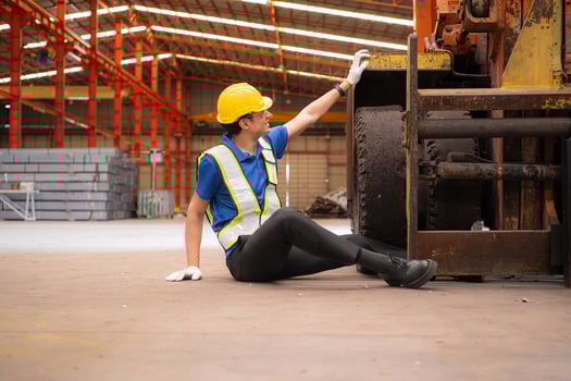 Young man working in a steel industry factory. He was critically hurt when a forklift ran over his leg and had to be transported to the hospital. photo
