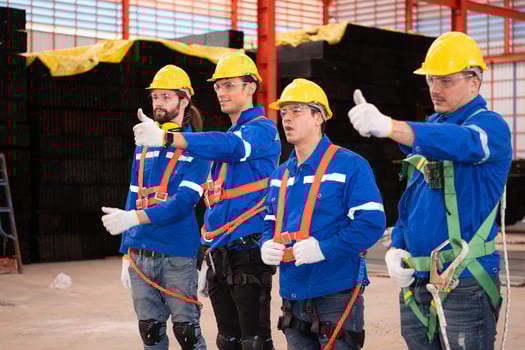 Portrait of a team of industrial workers standing together in a warehouse photo