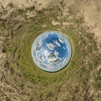 blue hole sphere little planet inside gravel sand round frame background photo