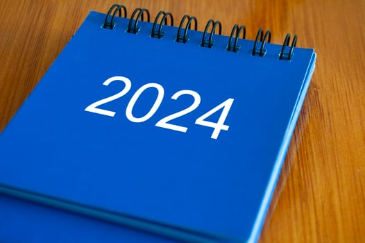 2024 table calendar on wooden desk. Time and calendar concept photo