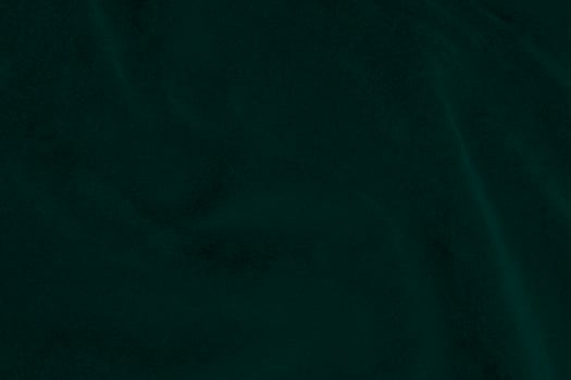 Green velvet fabric texture used as background. Emerald color panne fabric background of soft and smooth textile material. crushed velvet .luxury emerald tone for silk.. photo
