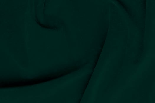 Green velvet fabric texture used as background. Emerald color panne fabric background of soft and smooth textile material. crushed velvet .luxury emerald tone for silk.. photo
