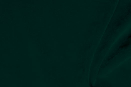 Green velvet fabric texture used as background. Emerald color panne fabric background of soft and smooth textile material. crushed velvet .luxury emerald tone for silk.. photo