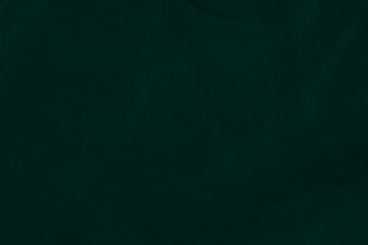 Green velvet fabric texture used as background. Emerald color panne fabric background of soft and smooth textile material. crushed velvet .luxury emerald tone for silk.. photo
