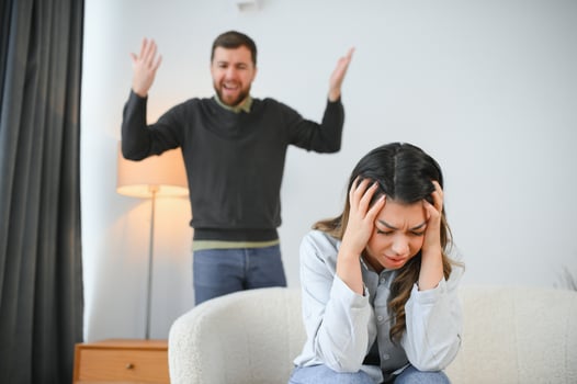 An agitated and upset husband shouts and looks at his wife, a quarrel between spouses. Family misunderstanding, quarrel photo