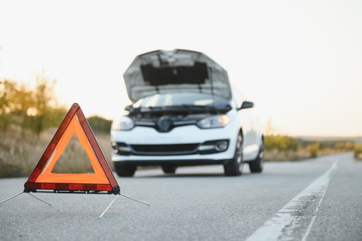 Broken car concept, breakdown triangle on road photo