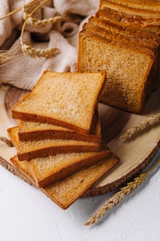 Board with slices of delicious toasted bread photo