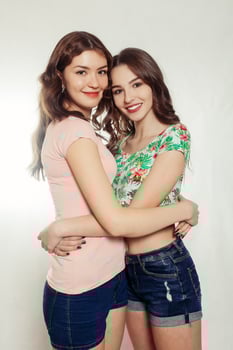 happy smiling pretty teenage girls or friends hugging photo