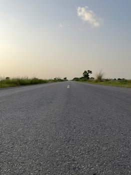 Road between the fields with the sky photo