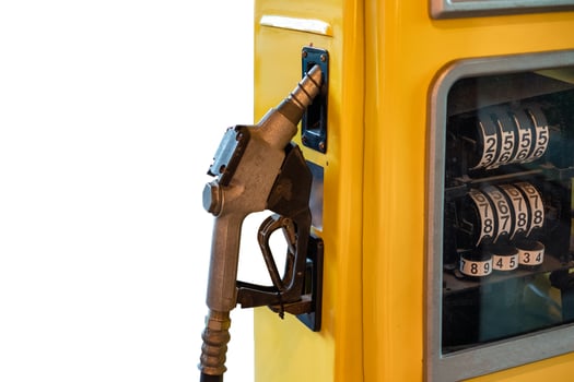 Fuel nozzle lock on yellow petrol pump on background photo