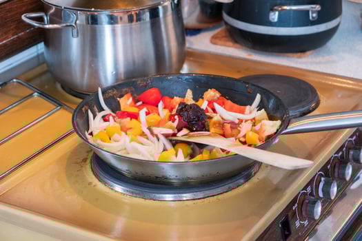 Wooden flipper frying chili sauce, vegetable,herb and oil photo