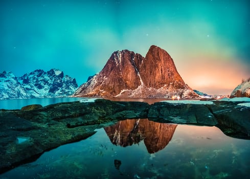 Aurora borealis or northern lights over Hamnoy fishing village in the night on winter at Lofoten Islands photo
