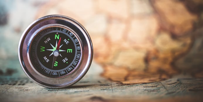 magnetic compass is placed on the map. Travel Ideas or Success photo