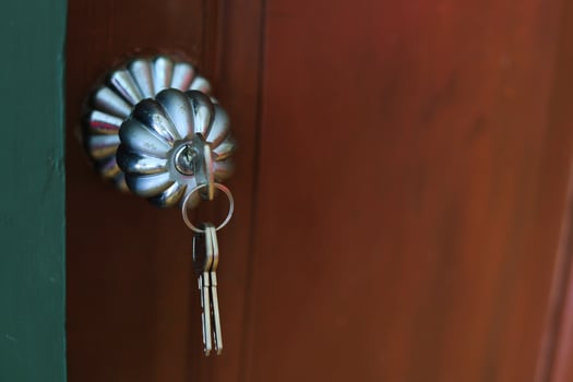 Door knob with key  on wooden door for unlock to enter the room. photo