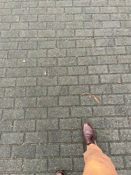leg with shoe on paved path photo