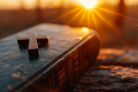 AI generated wooden cross and holy bible on the background of sunset photo