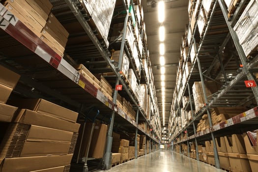 A large warehouse of furniture department stores. A warehouse where goods are stacked in record steel frames for replenishing stock of products sold to customers. photo