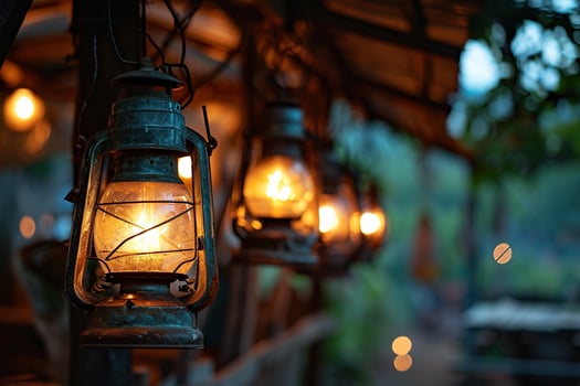 AI generated Old lanterns hanging on a wooden porch or terrace of a rustic house against a blurred sunset background photo