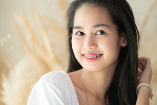 Portrait of a young asian woman with braces on her teeth photo