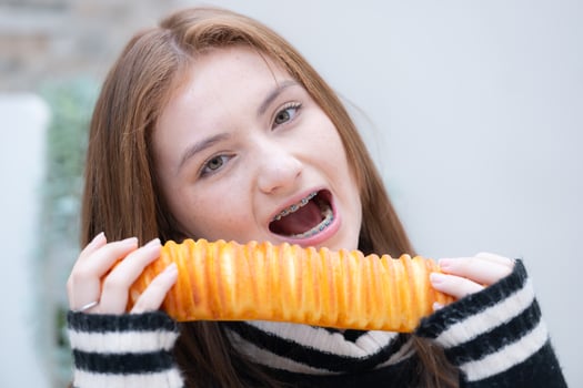 Portrait of Teenage girl eating bread in the kitchen at home photo
