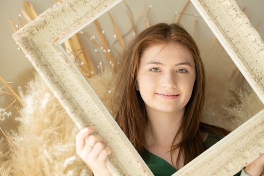 Portrait of Teenage girl with braces in picture frame photo