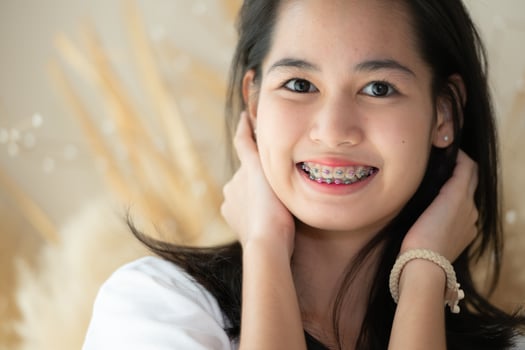 Portrait of a young asian woman with braces on her teeth photo