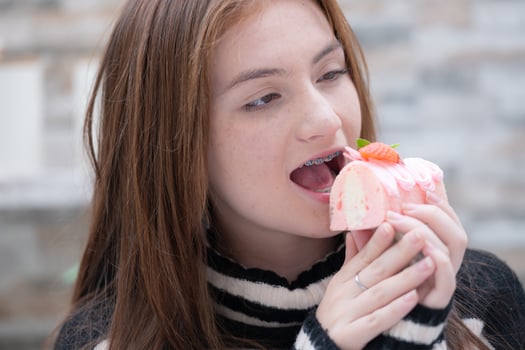 Portrait of Teenage girls eating a piece of cake photo