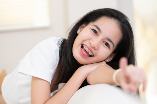 Portrait of a young asian woman with braces on her teeth photo