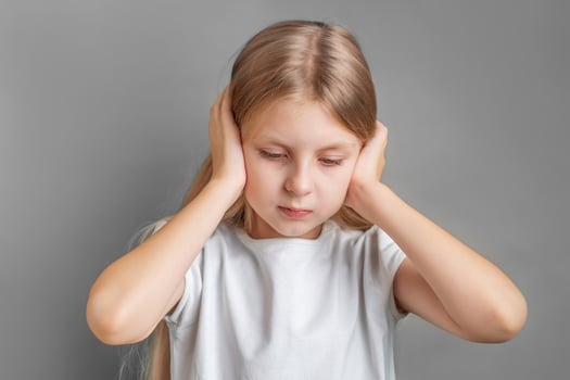 Little girl holding her head. photo