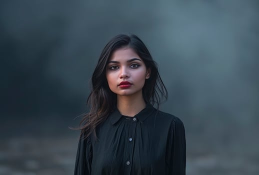lady in a black shirt posing for a photo in outdoor background