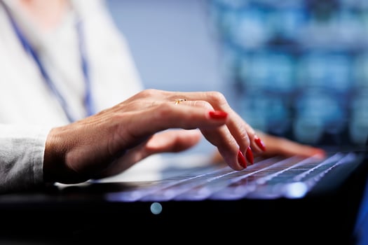 Skillful professional using laptop to make sure valuable data remains shielded from security complications, safeguarding high tech place against unauthorized access and vulnerabilities, close up photo