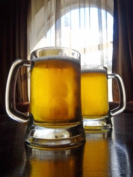 Two craft beer pints on the table detailed stock photo