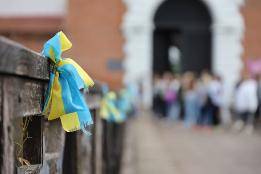 Ribbons in the colors of the national flag of Ukraine are tied to the handrail photo