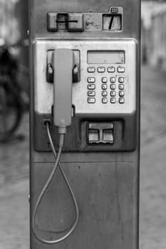 public telephone in black and white photo