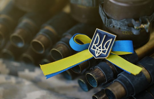 Ukrainian symbol on machine gun belt lies on ukrainian pixeled military camouflage photo
