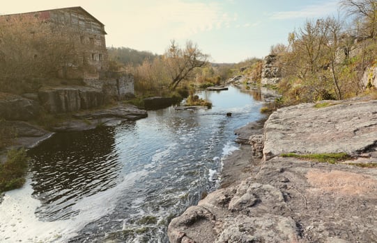 Rocky bank, mountain landscape. View of mountain river in early spring. Nature landscape, wilderness. Tikich river photo