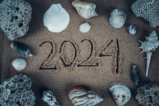 Handwritten 2024 on clean beach sand. Happy New Year photo