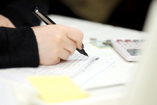 Accountant fill American tax form 1040 Individual income tax return in end of tax period. Taxation and paperwork routine photo