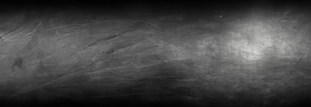 a black and white photo of a wall with some paint on it