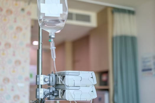Close up medical intravenous IV drip in hospital background photo