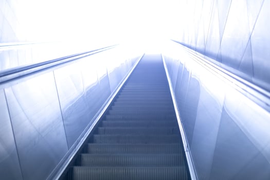 escalator leads somewhere to the light photo
