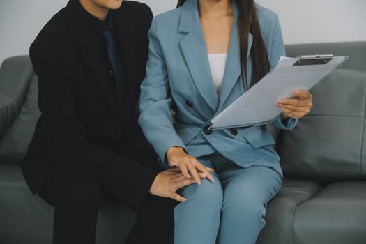 Sexsual harassment in workplace. Unhappy female employee looking at hand of boss touch at her shoulder and feeling disgusted. photo