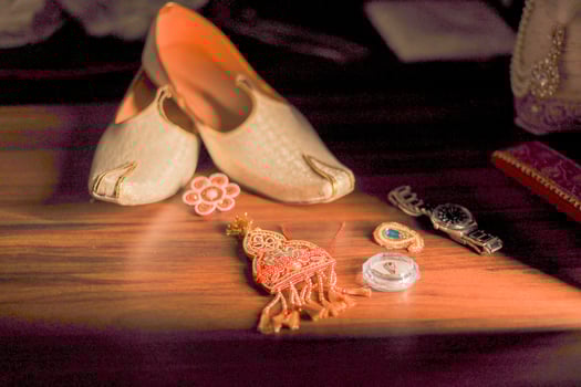 Indian groom's traditional wedding jewelry and shoes close up photo