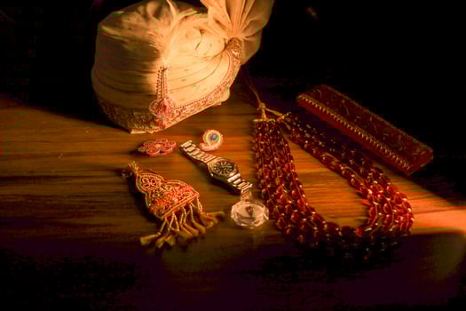Indian groom's traditional wedding jewelry and shoes close up photo