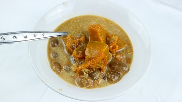 Kolak pisang or banana and pumpkin is popular Indonesian dessert made from banana, pumpkin, sugar palm fruit cooked with coconut milk, palm sugar and pandanus leaves. Very popular during Ramadhan. photo