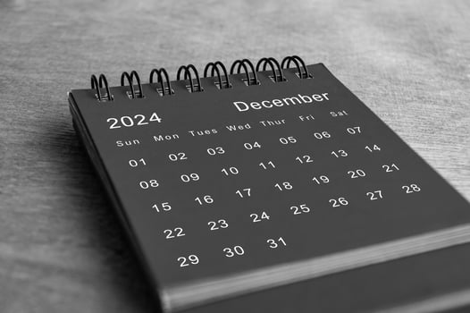 Black and white December 2024 desk calendar on wooden desk. Calendar and new month concept photo