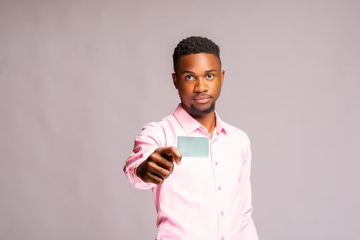 close up of a handsome man holding his voters card photo